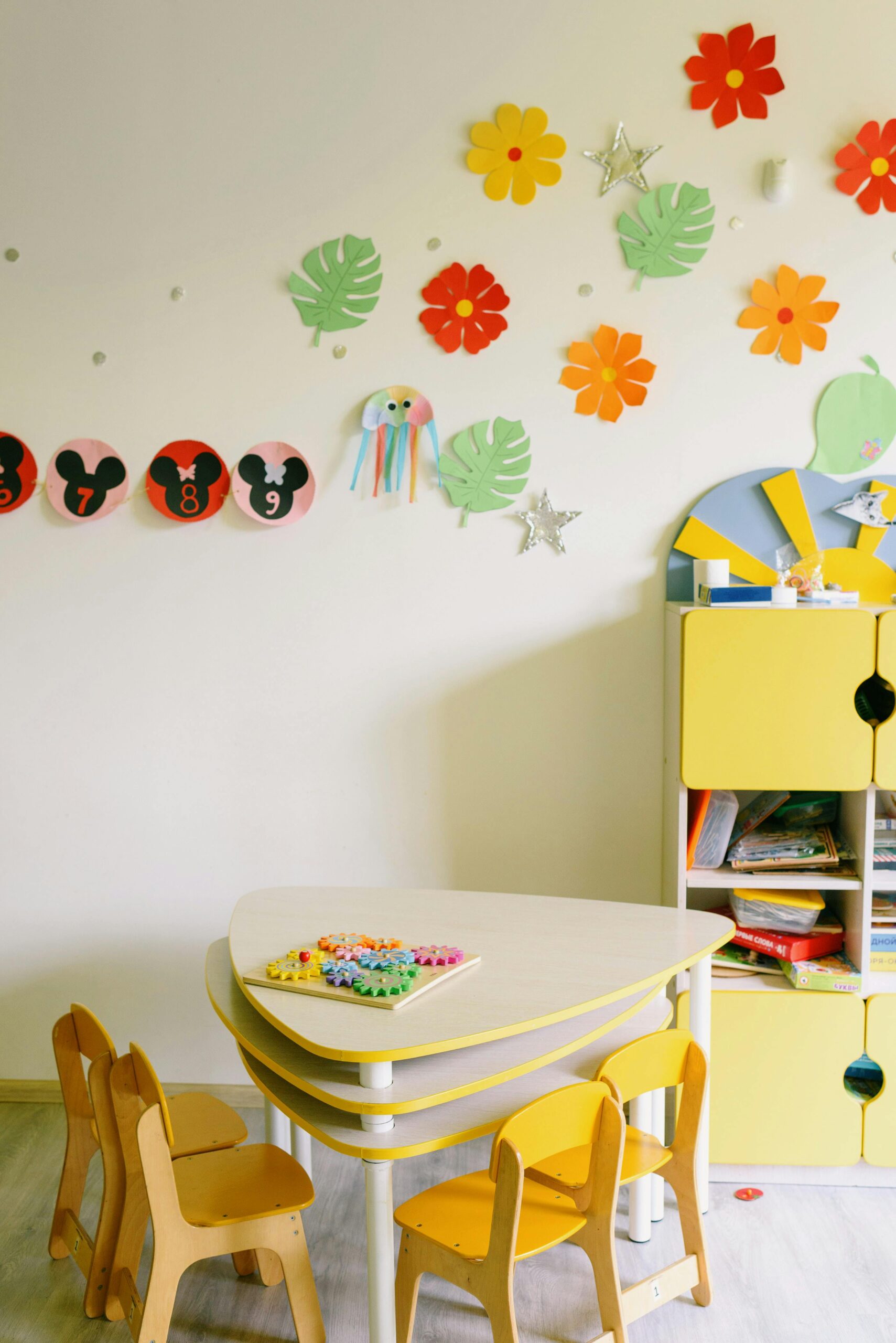 Brightly decorated children's classroom with colorful crafts and furniture.